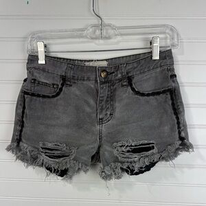 Free People women’s faded gray & black cutoff distressed denim shorts. Size 24